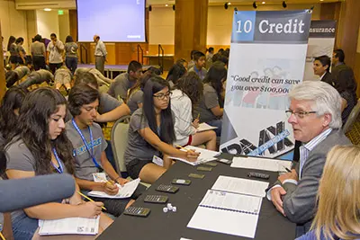 Student benefit from a financial knowledge test at a Real Money Experience event.