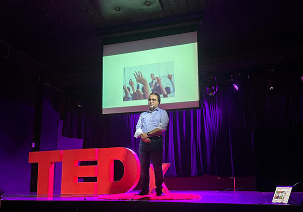 Alimursal Ibrahimov speaking TEDx event 3 600w Contributions to Texas communities provided by Personal Finance Expert LearnTheMoney