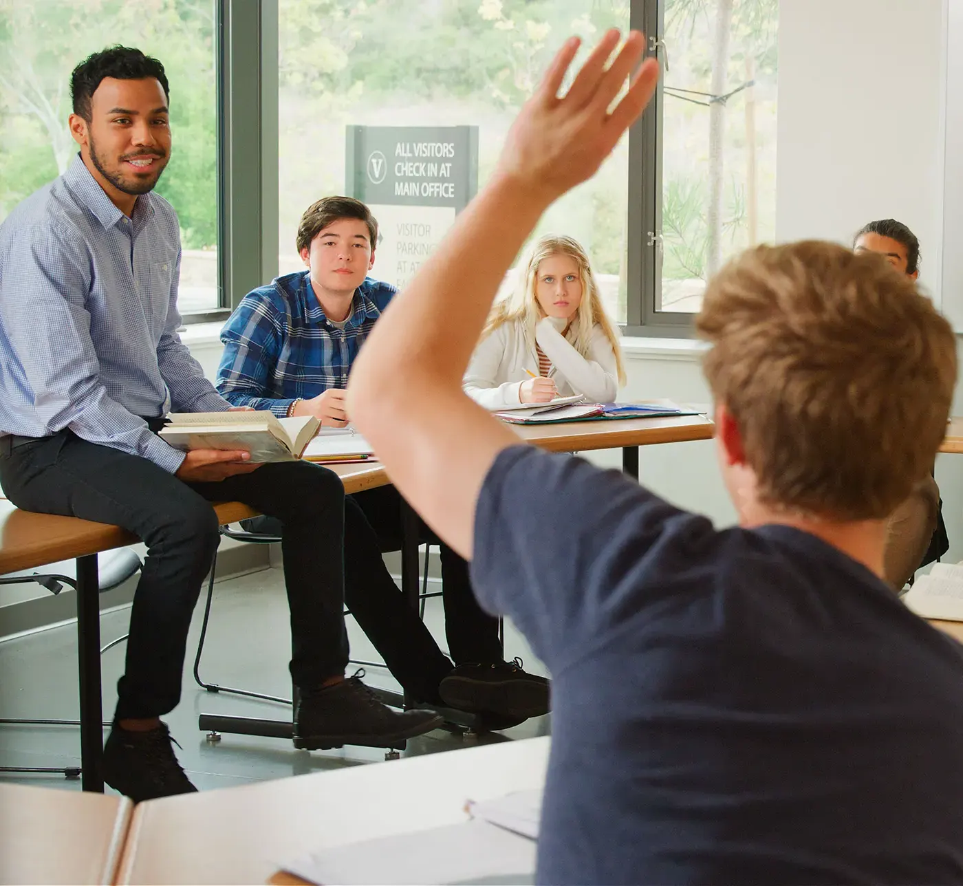 educator having high school classroom discussion with students-portrait