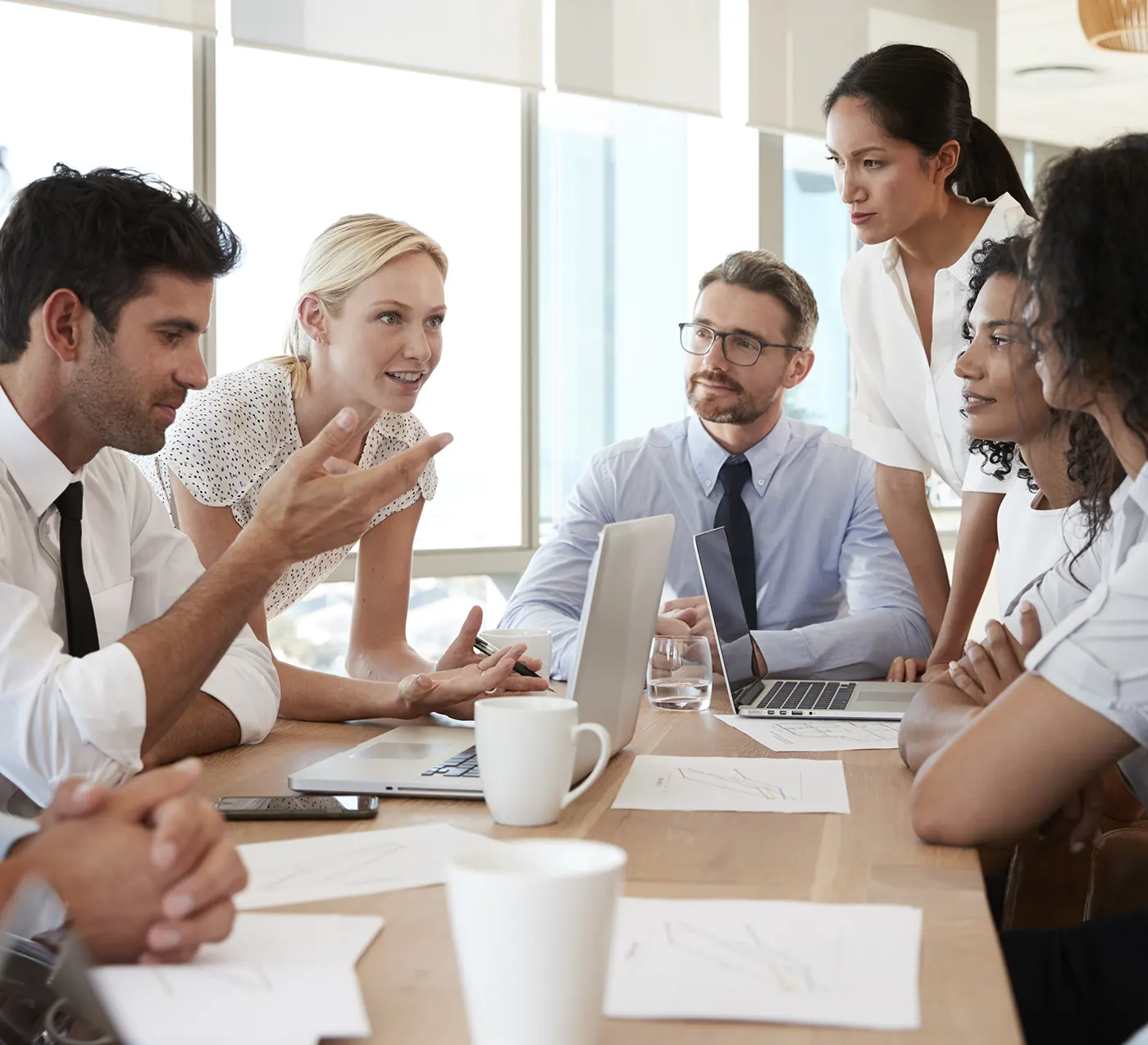 group of professional people talking around a table
