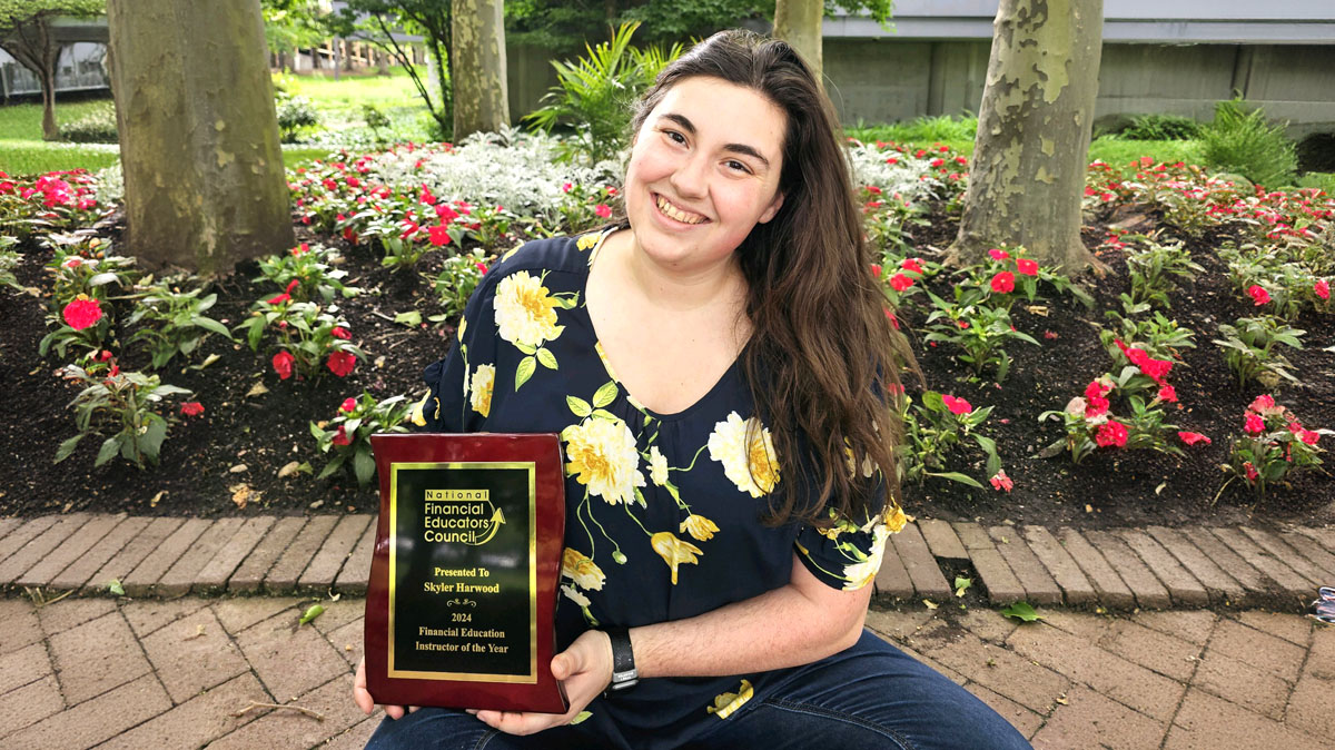 skyler harwood FEIY 2024 2 with award Skyler Harwood, Financial Education Instructor of the Year for 2024, with Students