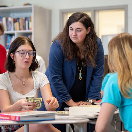 OLYMPUS DIGITAL CAMERA Skyler Harwood, Financial Education Instructor of the Year for 2024, with Students