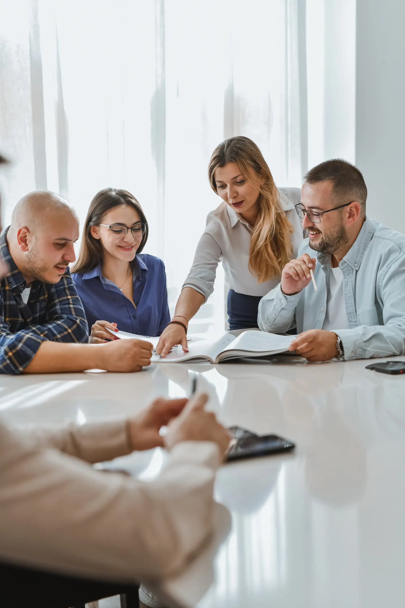 small group of professionals rewing materials together